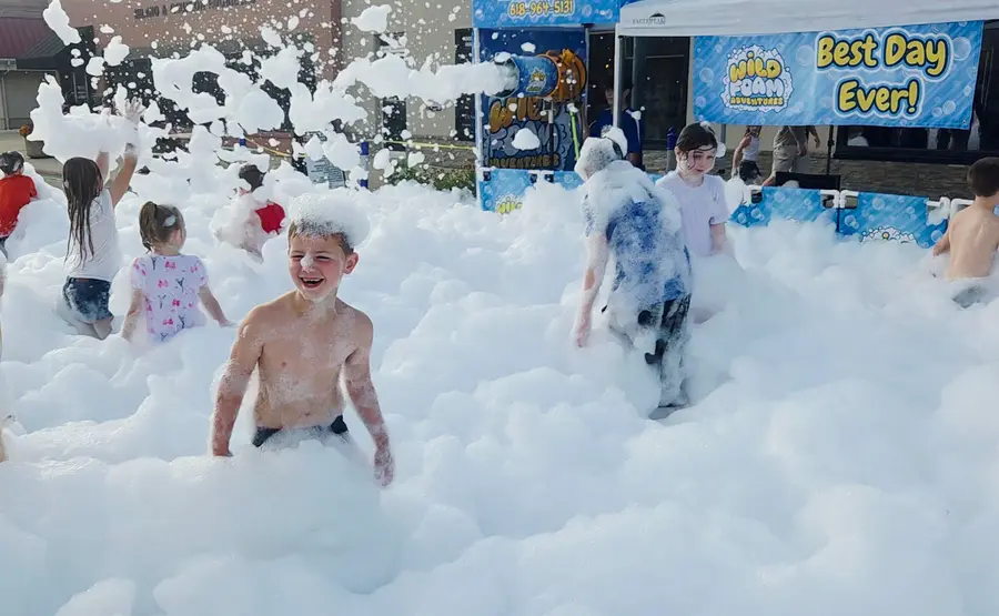 A foam cannon set up on a lawn